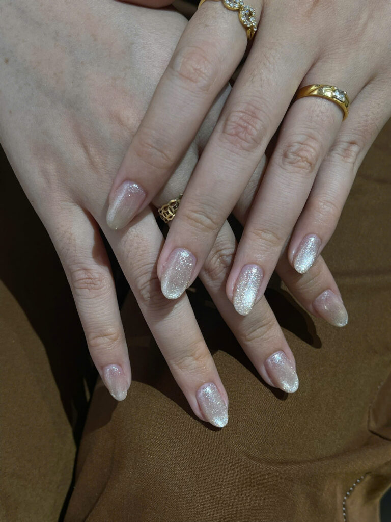 Champagne glitter cat-eye gel nails on almond shape at Art Spa 2, Hoi An