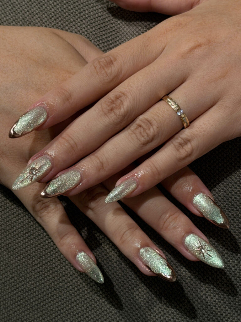 Green chrome stiletto nails with gold edges at Art Spa 2, Hoi An