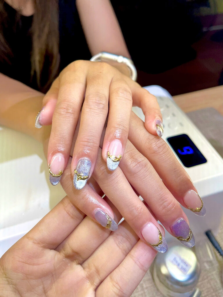Lilac cat-eye nails with gold chrome lines at Art Spa 2, Hoi An