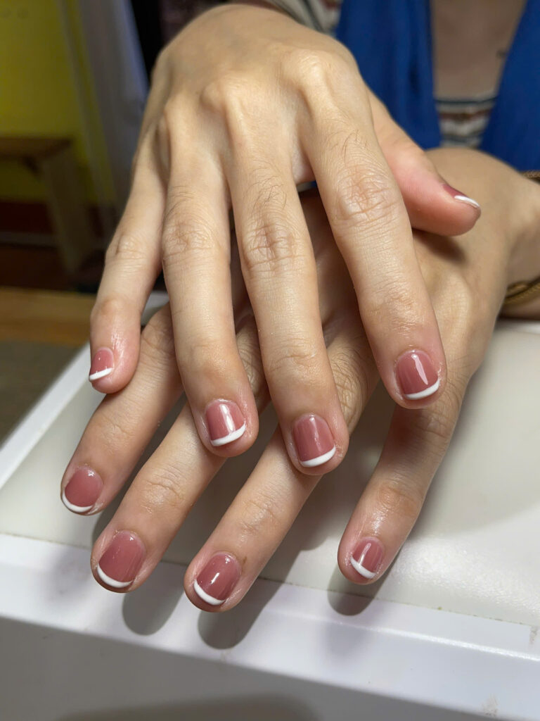 Short pink gel manicure with white French tips at Art Spa 2, Hoi An